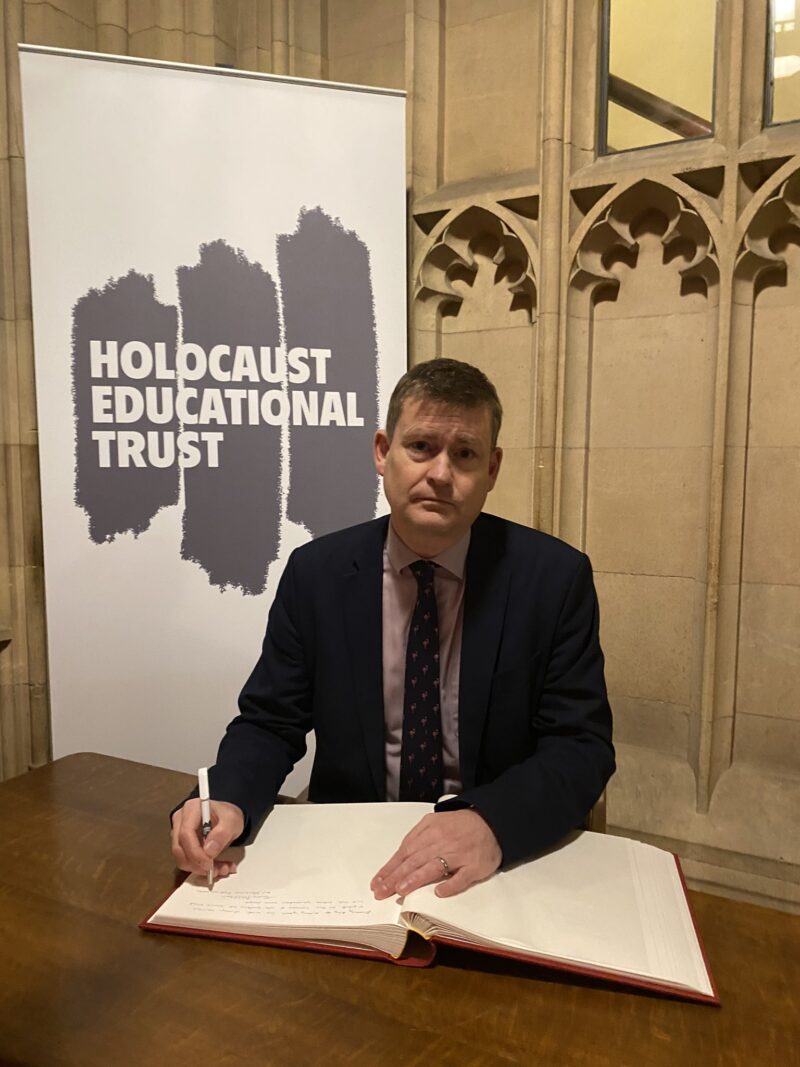 Justin signing the Holocaust Educational Trust’s Book of Commitment 