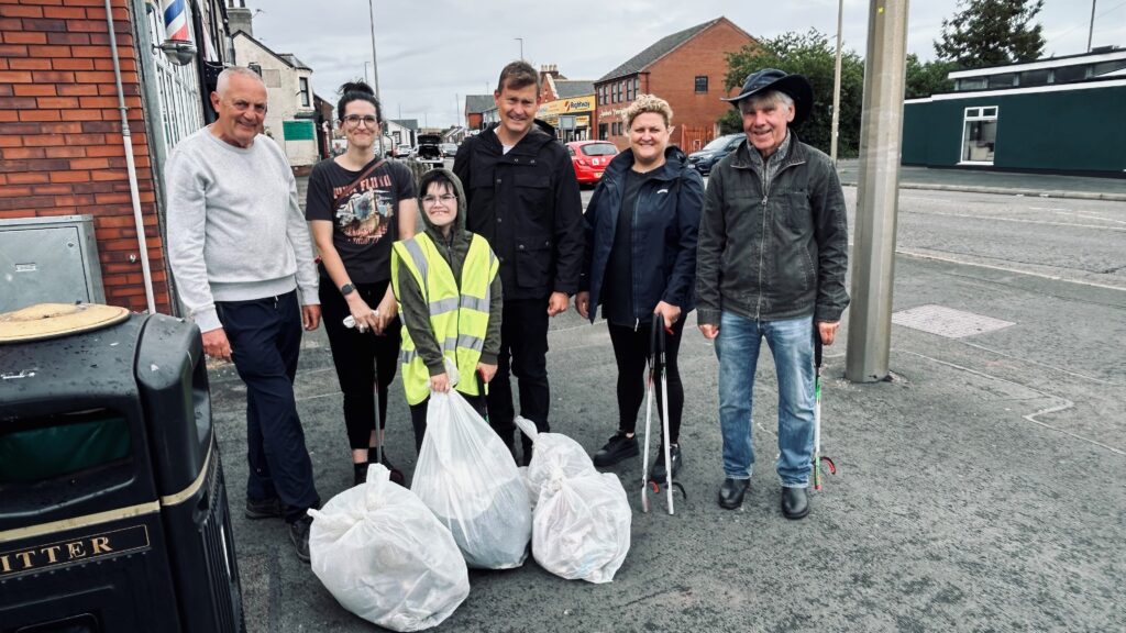 Jackson, eight, with his mum Leanne, Justin Madders MP and local councillors Paul Donovan (Sutton Villages), Karen Shore (Central and Grange) and Bob Bisset (Central and Grange) pose for a picture in Chester Road, Ellesmere Port, after completing their clean-up.